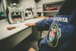 Guardia di sicurezza in ufficio con contatore di banconote.
