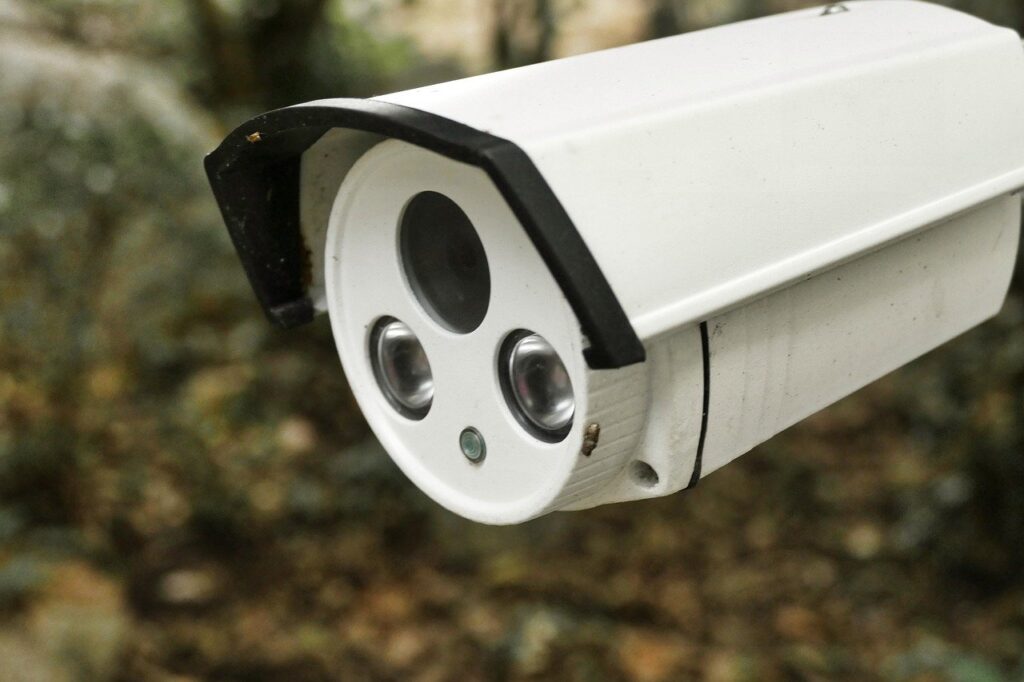 Telecamera di sicurezza bianca con sfondo sfocato.